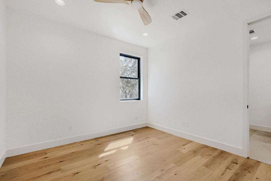 Spare room featuring light wood-type flooring, ceiling fan, and recessed lighting Spare room featuring light wood-type flooring, ceiling fan, and recessed lighting