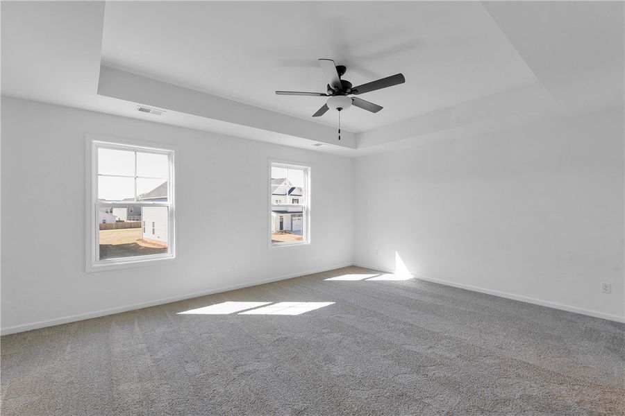 This spacious bedroom offers ample natural light a