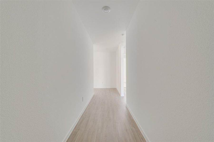 Hallway featuring light wood-type flooring