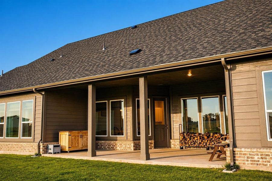Spacious covered patio featuring concrete flooring and supportive columns