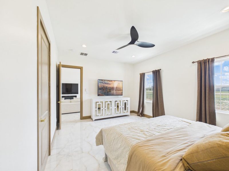 Primary bedroom with plenty of natural light and an en suite bathroom