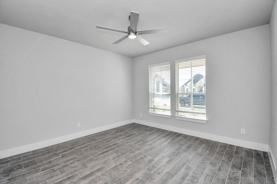 Step into the inviting home office, where elegant tile flooring adds a touch of freshness and comfort to the workspace. Natural light pours through the window, creating an inspiring environment for productivity and focus.