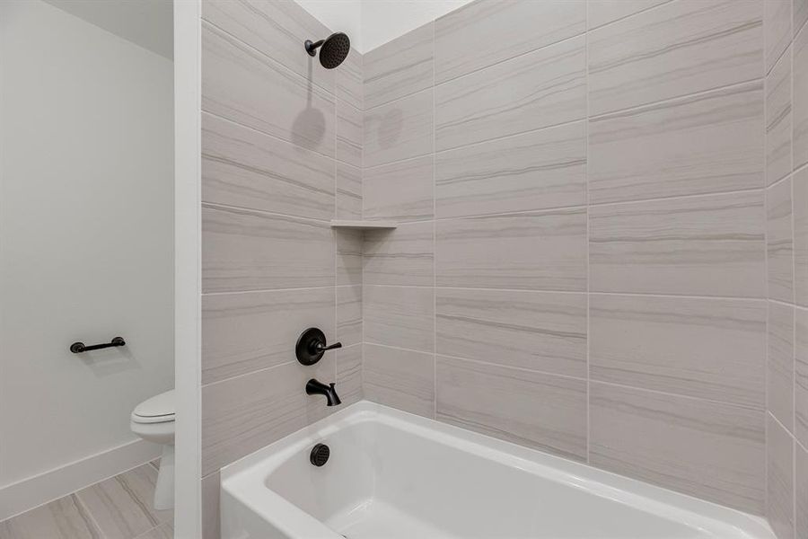 Bathroom with shower / bathtub combination and toilet