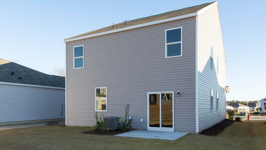 Front exterior of a new home in The Pines at Blake Farm, Wilmington, NC, highlighting curb appeal (Image 2).