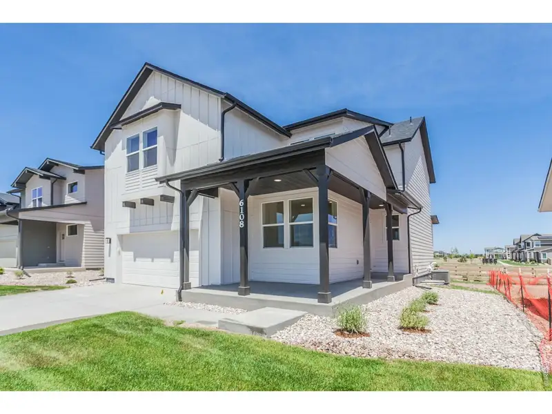 Front exterior of a new home in Trailside, Timnath, CO, highlighting curb appeal (Image 25). Front exterior of a new home in Trailside, Timnath, CO, highlighting curb appeal (Image 25).