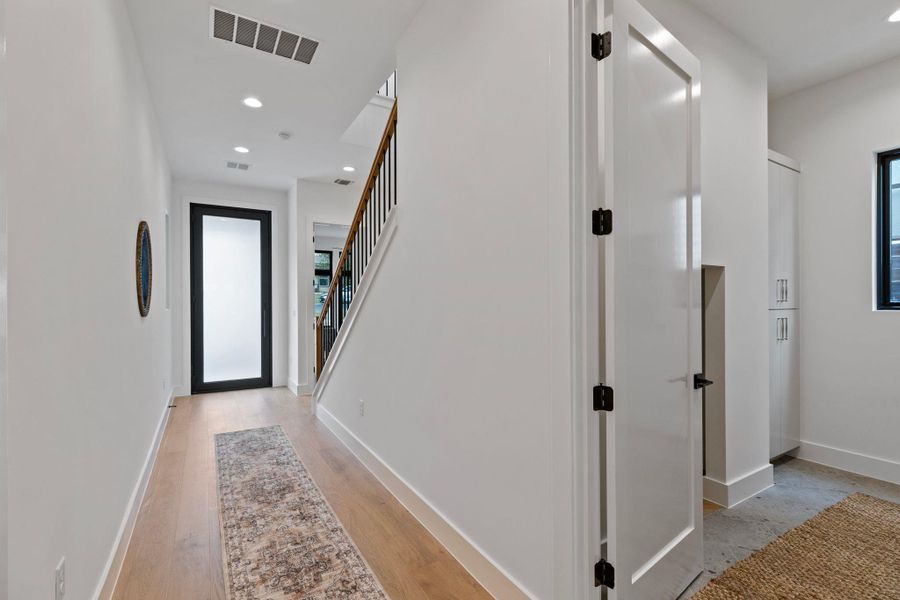 Corridor featuring stairs, baseboards, recessed lighting, and light wood finished floors