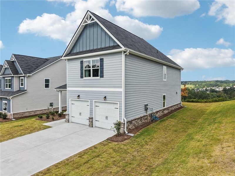 Front exterior of a new home in The Hills at Cedar Creek, Winder, GA, highlighting curb appeal (Image 21).