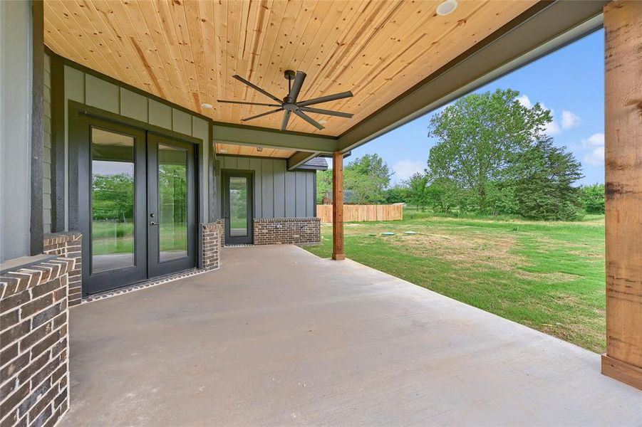 View of patio / terrace with ceiling fan, fence, and french doors
