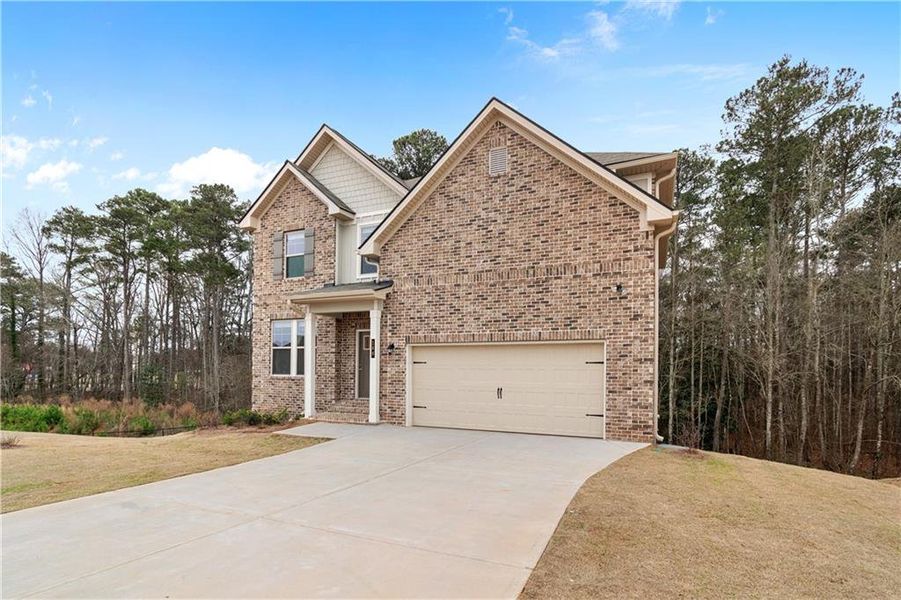 Front exterior of a new home in Cedar Grove Commons, Conley, GA, highlighting curb appeal (Image 15). Front exterior of a new home in Cedar Grove Commons, Conley, GA, highlighting curb appeal (Image 15).