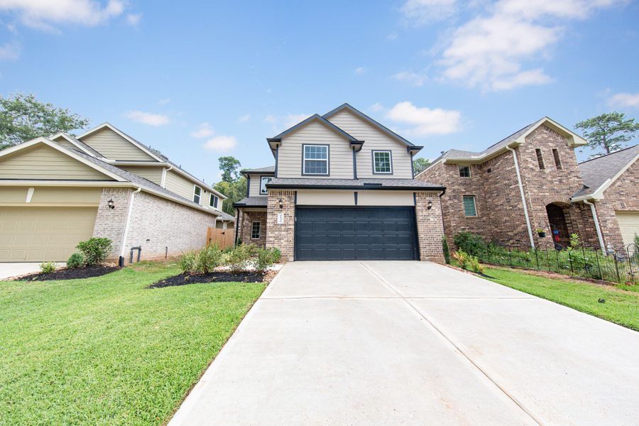 Front exterior of a new home in Lake Conroe Area Homes, Montgomery, TX, highlighting curb appeal (Image 12).