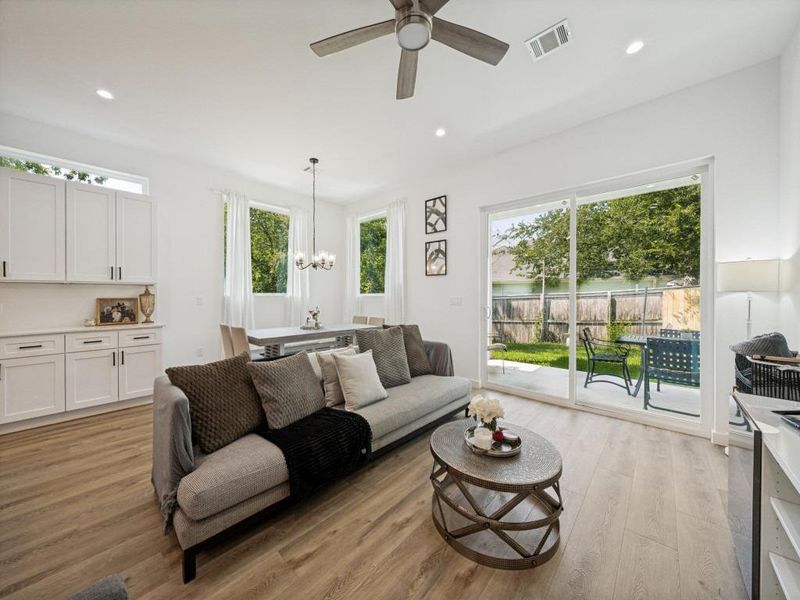 A welcoming living area flows seamlessly to the backyard through wide sliding glass doors. A welcoming living area flows seamlessly to the backyard through wide sliding glass doors.