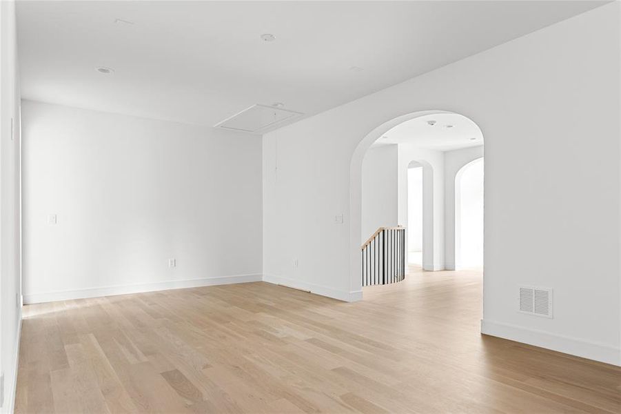 Unfurnished room with attic access and light wood-type flooring