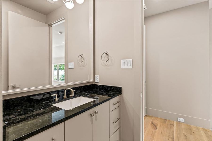 Bathroom featuring wood finished floors and vanity Bathroom featuring wood finished floors and vanity