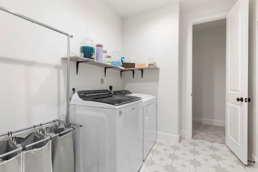 Spacious utility room with direct access from the primary closet