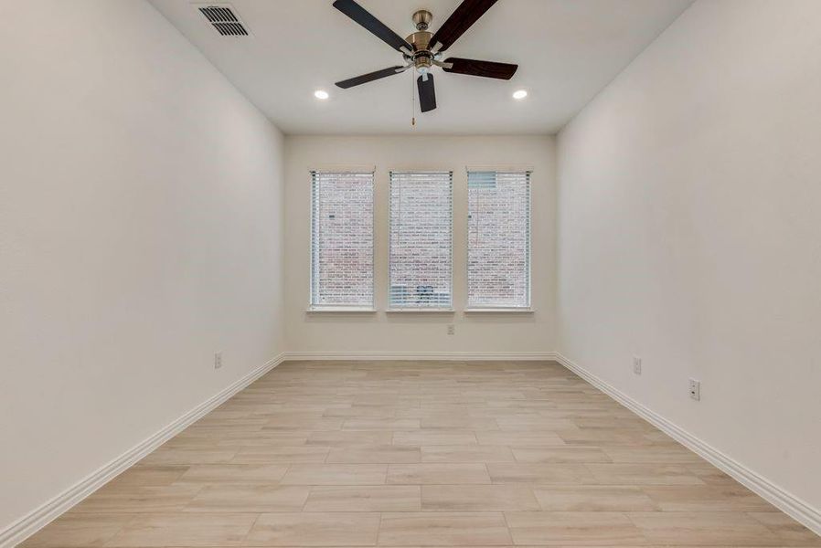 Empty room featuring ceiling fan and light hardwood / wood-style floors