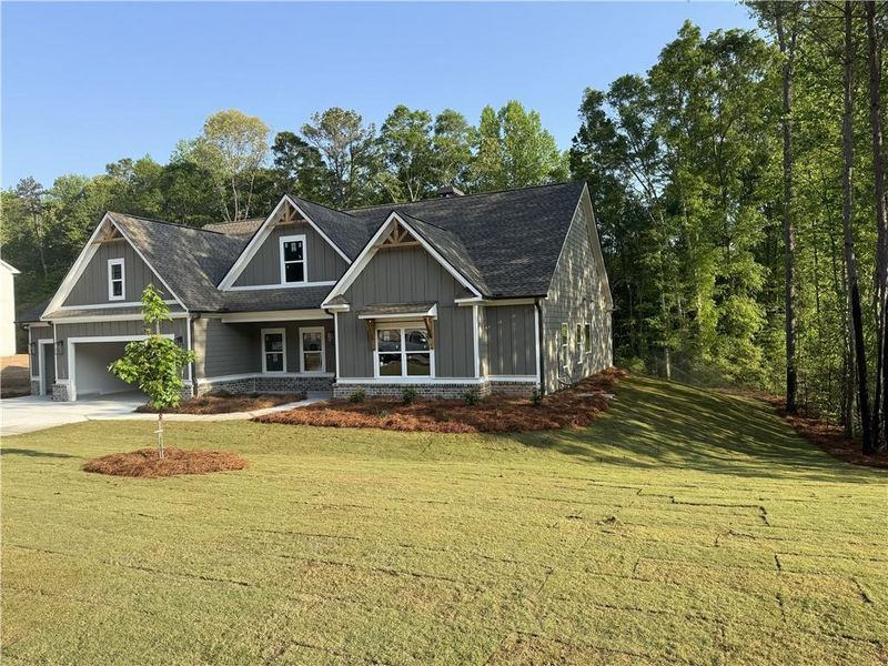 Front exterior of a new home in Woodland Hills, Loganville, GA, highlighting curb appeal (Image 3). Front exterior of a new home in Woodland Hills, Loganville, GA, highlighting curb appeal (Image 3).