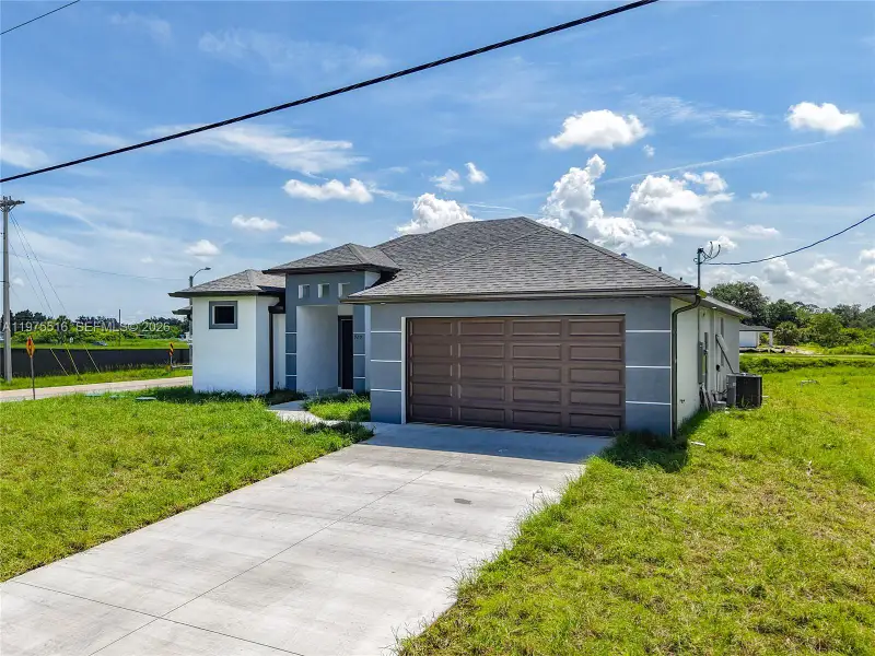 Front exterior of a new home in , Lehigh Acres, FL, highlighting curb appeal (Image 26). Front exterior of a new home in , Lehigh Acres, FL, highlighting curb appeal (Image 26).