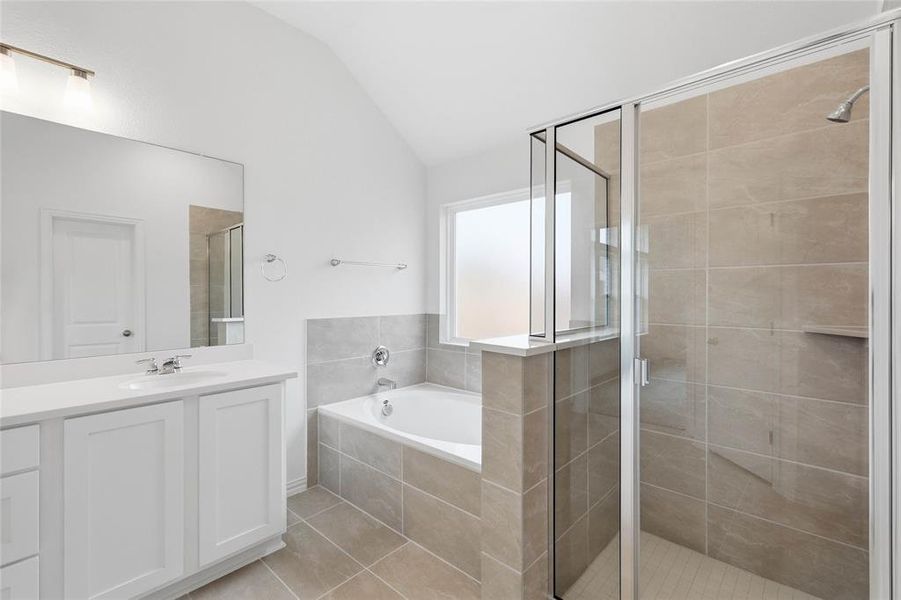 Contemporary bathroom featuring a white vanity with an undermount sink, a framed glass shower, and a built-in soaking tub