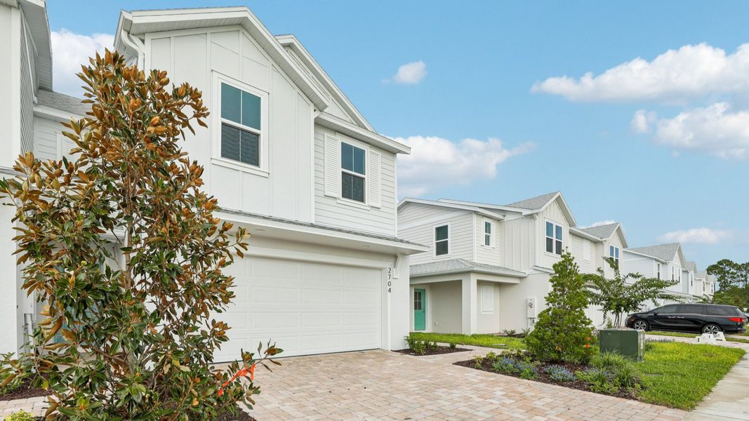 Front exterior of a new home in Cyrene at Harmony, St. Cloud, FL, highlighting curb appeal (Image 21).