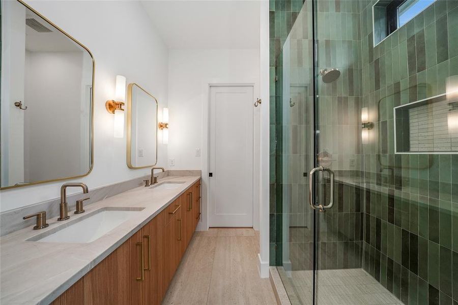 Bathroom with double vanity, a stall shower, and light wood finished floors Bathroom with double vanity, a stall shower, and light wood finished floors
