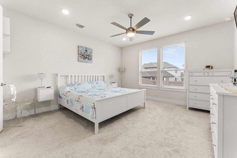 The master bedroom has a ceiling fan, recessed lighting, two-inch blinds, and a big closet which has convenient, direct access to the laundry room.