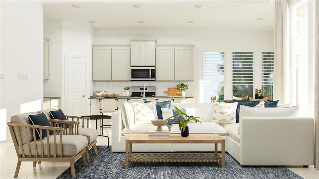 Living area featuring healthy amount of natural light, recessed lighting, and dark wood-type flooring Living area featuring healthy amount of natural light, recessed lighting, and dark wood-type flooring
