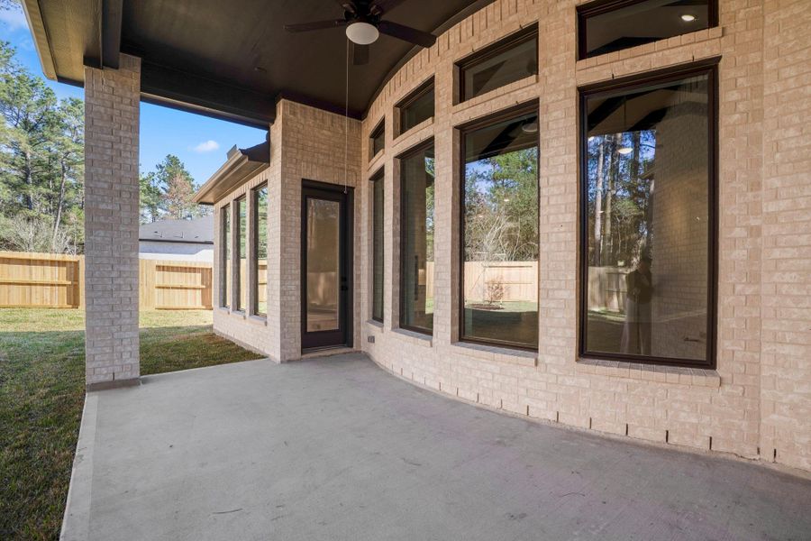 Exterior details and patio area of a home in The Woodlands Hills, Willis (Image 24).
