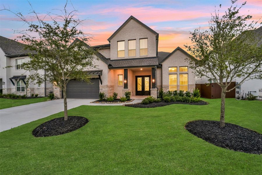 Front exterior of a new home in Meridiana, Manvel, TX, highlighting curb appeal (Image 25).
