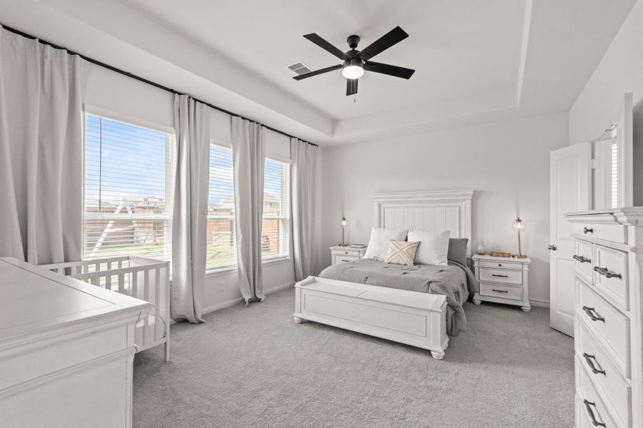 The primary bedroom welcomes you with bright natural light, large windows, and the perfect view of the serene yard. It sits at the back of the home offering additional privacy and easily fits a king size bed plus furniture!