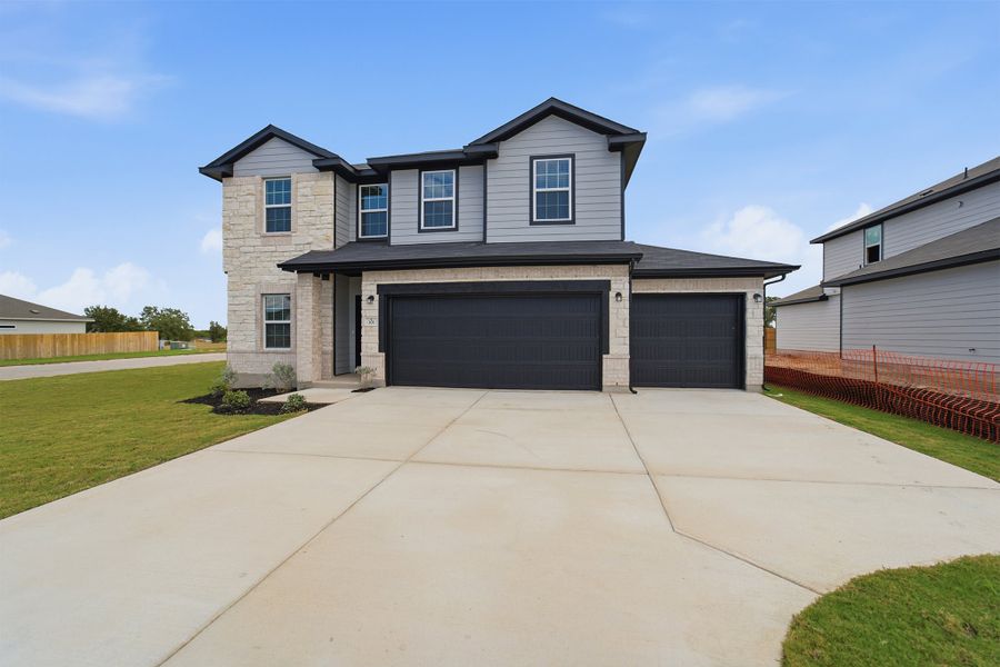 Front exterior of a new home in Grande Estates, Bertram, TX, highlighting curb appeal (Image 26). Front exterior of a new home in Grande Estates, Bertram, TX, highlighting curb appeal (Image 26).