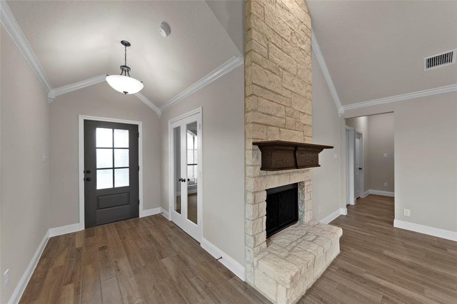 Stone fireplace with a dark wood mantelpiece