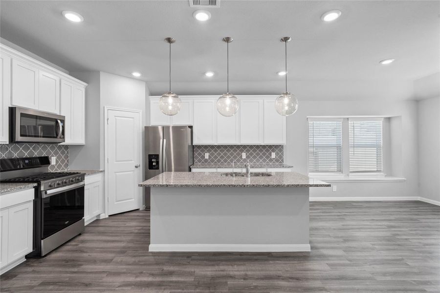 This spacious kitchen and dining combination keeps everyone connected while offering a large center island, abundant cabinetry, and a bright breakfast nook for seamless everyday living and entertaining. This spacious kitchen and dining combination keeps everyone connected while offering a large center island, abundant cabinetry, and a bright breakfast nook for seamless everyday living and entertaining.