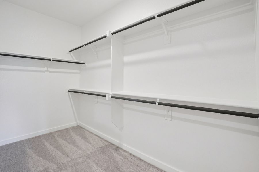 A white wall with a metal railing.