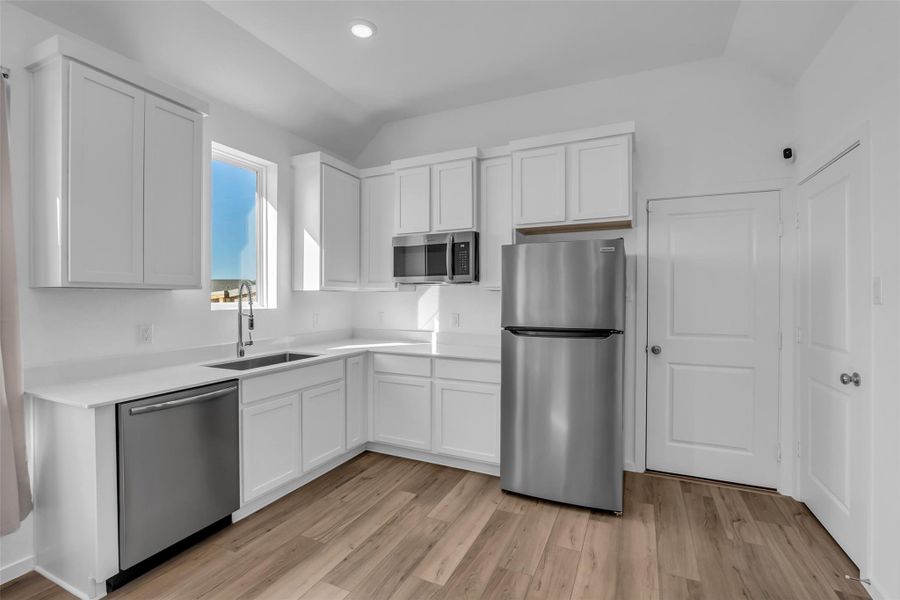 Next Gen Kitchenette:A polished kitchenette with stainless appliances and crisp cabinetry, positioned for true independence. The private door leads directly to the attached garage, offering a rare, self-contained living setup. Next Gen Kitchenette:A polished kitchenette with stainless appliances and crisp cabinetry, positioned for true independence. The private door leads directly to the attached garage, offering a rare, self-contained living setup.