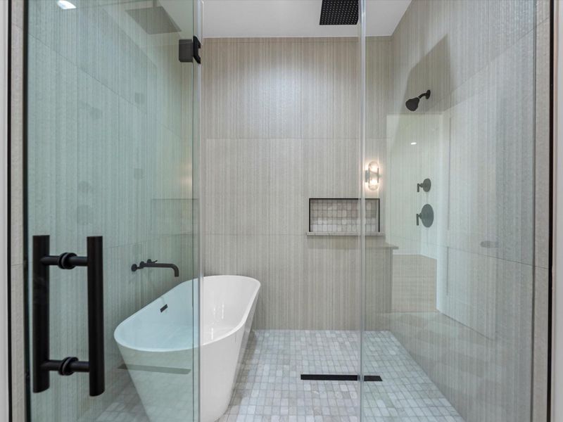 Primary bathroom, featuring free standing tub, and oversized stand up shower. You will also notice separated his and hers closets.