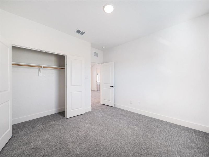 Unfurnished bedroom with carpet and a closet