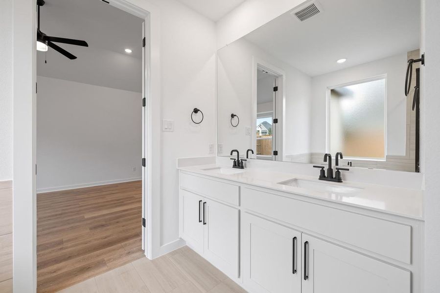 Bathroom featuring double vanity, light wood-style floors, recessed lighting, and ceiling fan Bathroom featuring double vanity, light wood-style floors, recessed lighting, and ceiling fan