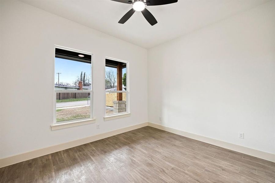 Unfurnished room featuring light wood-type flooring and a ceiling fan