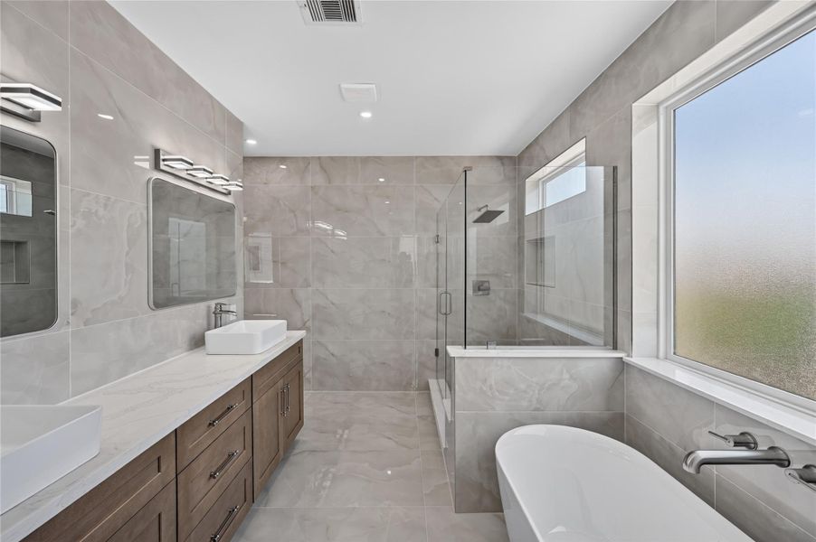 full view of this beautiful bathroom that's fully tiled!