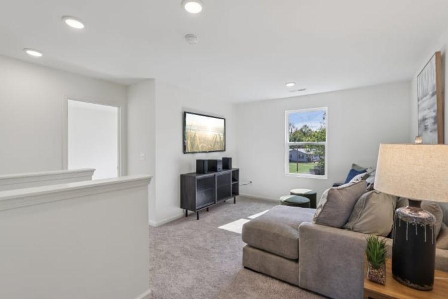 A living room with a couch and a tv. A living room with a couch and a tv.