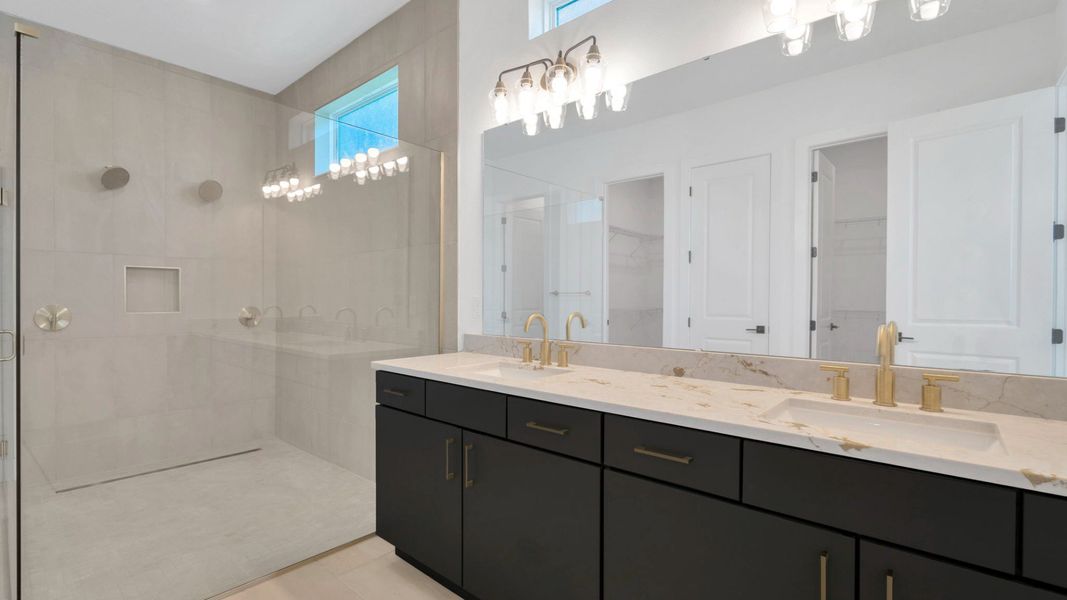 The Primary Bathroom of a DRB Homes Grand Hawk which is offered as a home plan at Serengeti in Spring Hill, FL.