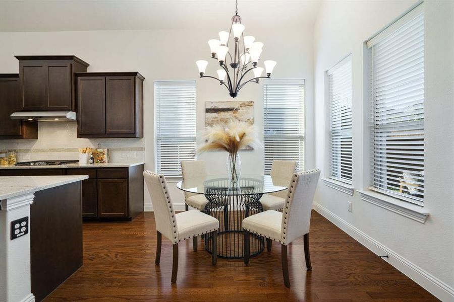 This breakfast room is wrapped in windows, flooding the space with sunshine for those bright, happy mornings.