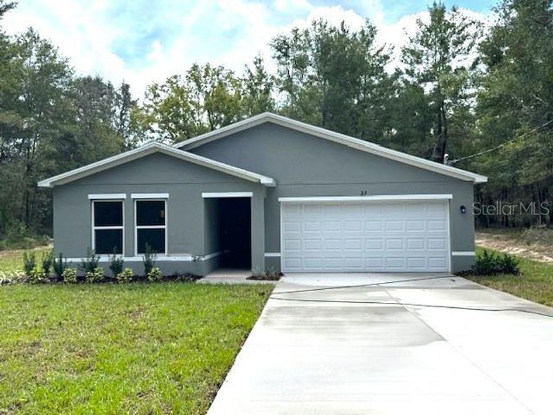 Front exterior of a new home in The Collection at Ocklawaha, Ocklawaha, FL, highlighting curb appeal (Image 1). Front exterior of a new home in The Collection at Ocklawaha, Ocklawaha, FL, highlighting curb appeal (Image 1).