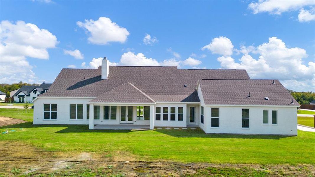 Back of house featuring a yard