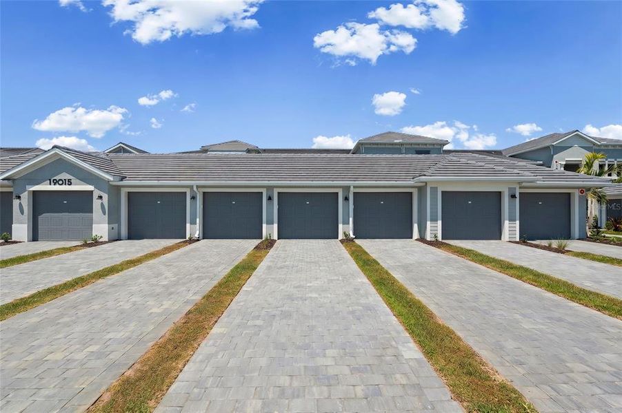 Front exterior of a new home in Calusa Country Club, Lakewood Ranch, FL, highlighting curb appeal (Image 27).