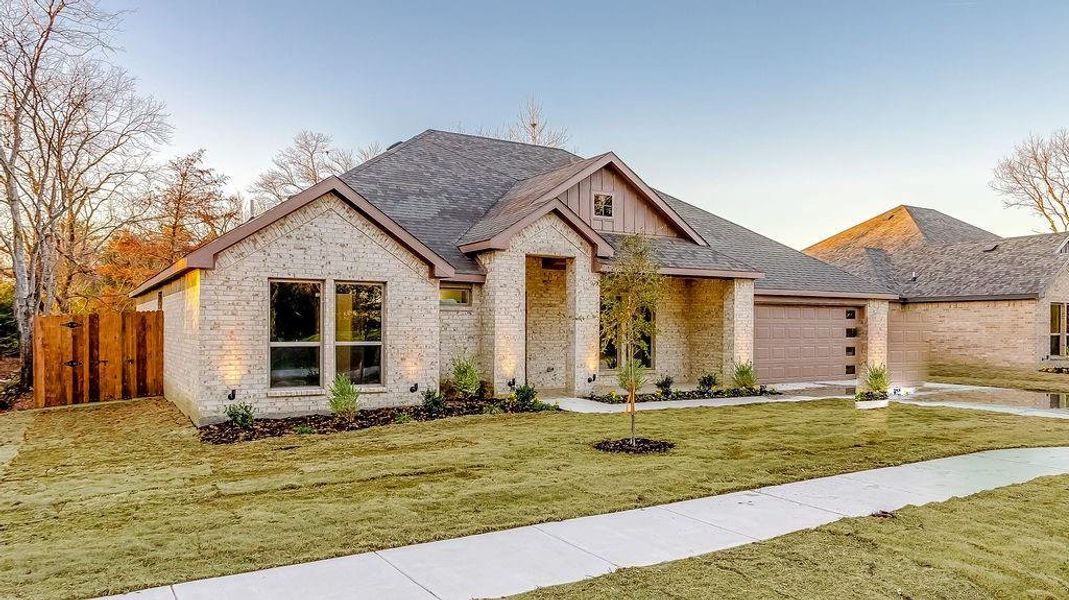 View of front of property with a front yard and a garage