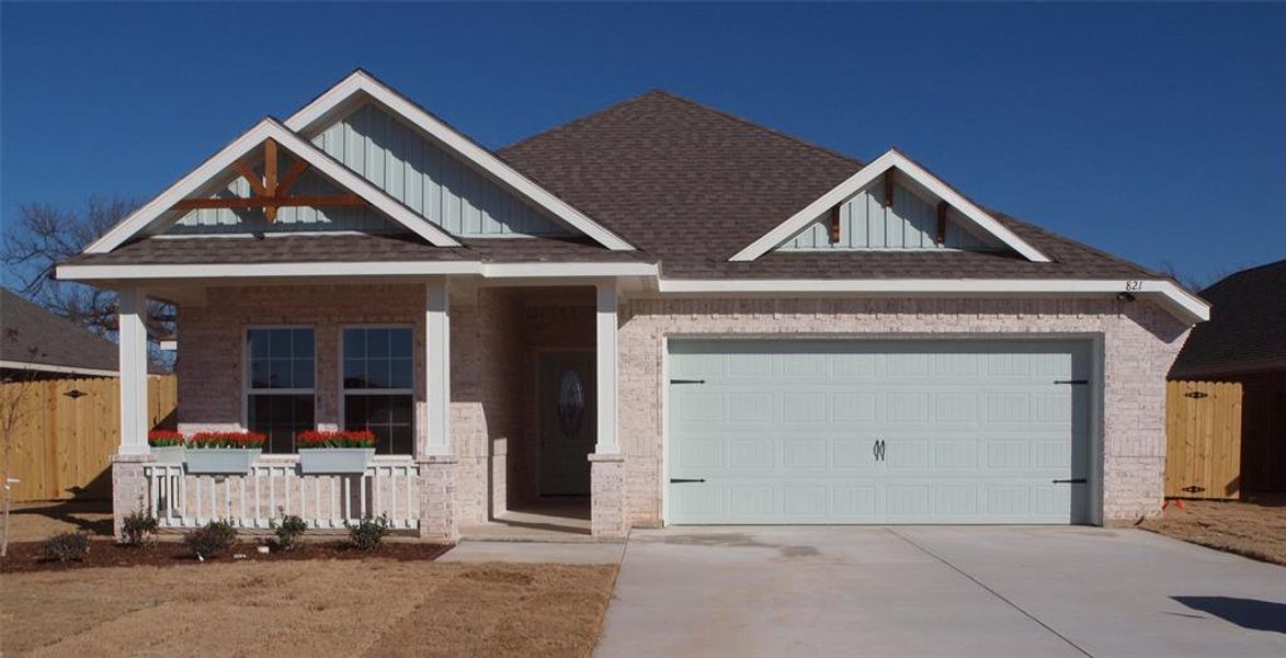 Craftsman inspired home featuring a garage and a porch