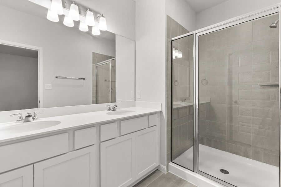Dual vanities in Primary Bath and walk-in shower - Representative Photo
