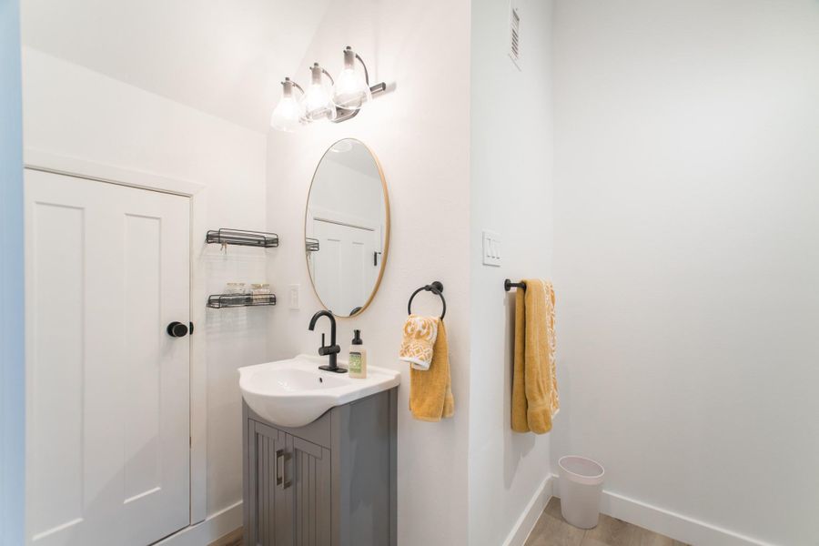 The ensuite bathroom features beautiful floors, creating a striking contrast against the white walls The ensuite bathroom features beautiful floors, creating a striking contrast against the white walls