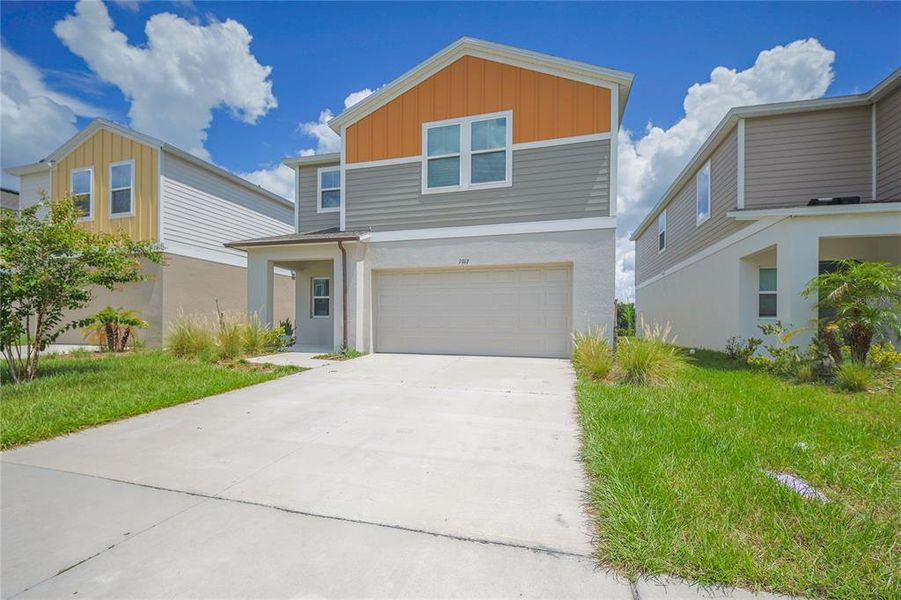 Front exterior of a new home in Pasadena Point, Wesley Chapel, FL, highlighting curb appeal (Image 2). Front exterior of a new home in Pasadena Point, Wesley Chapel, FL, highlighting curb appeal (Image 2).